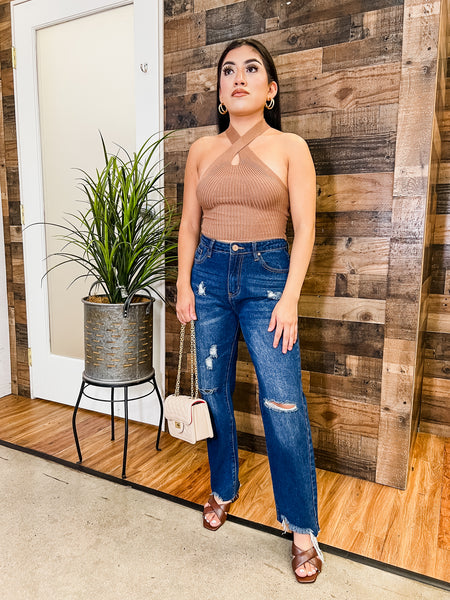 woman wearing brown sleeveless shirt with blue jeans