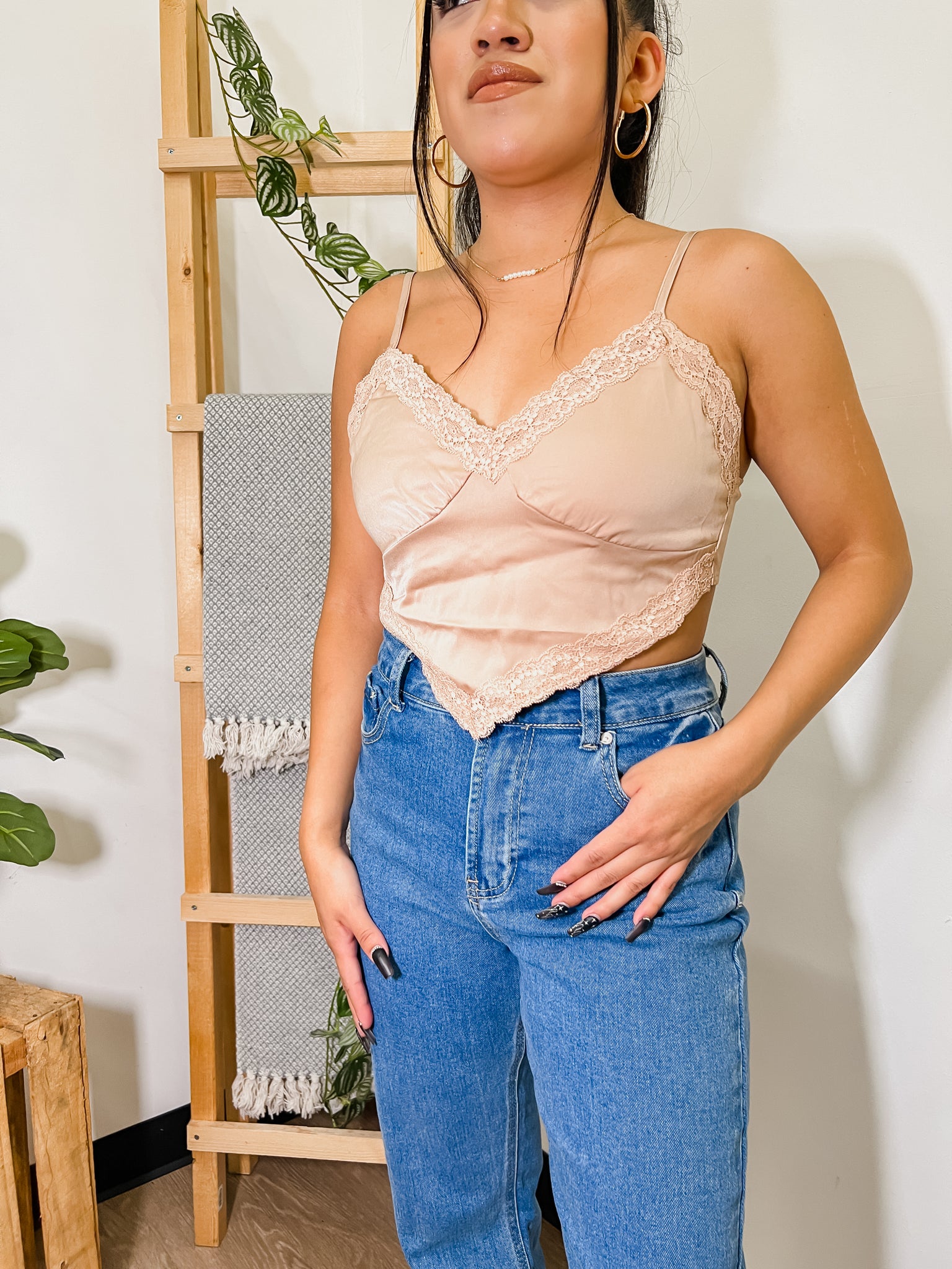 close up of woman wearing a beige colored shirt with jeans